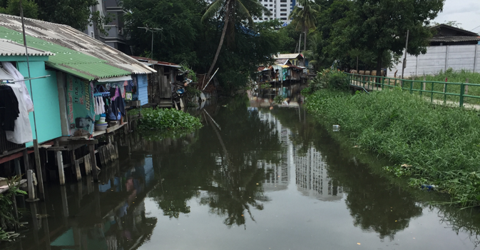 Thailand precarious housing on stilts over river